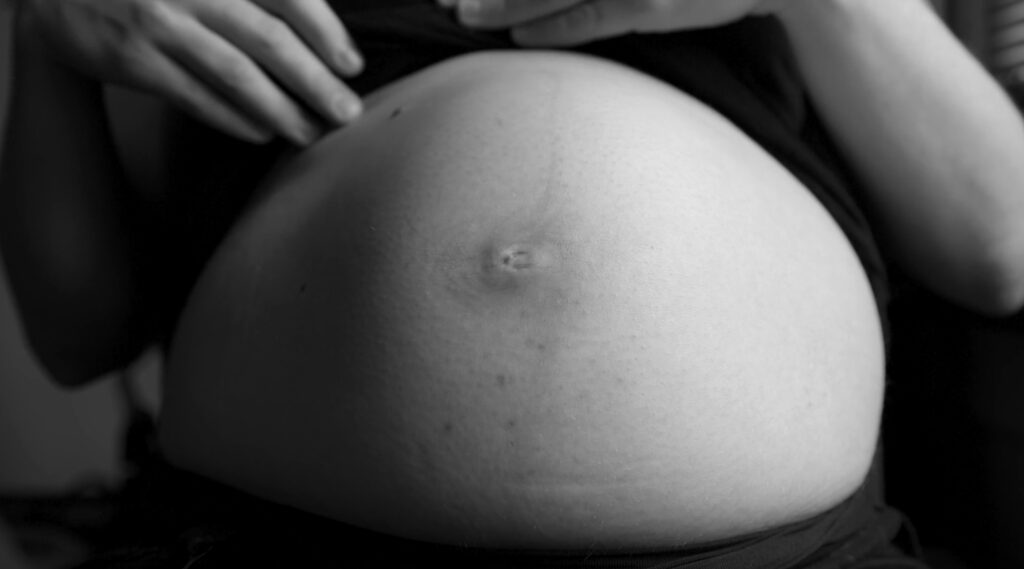 A pregnant belly seen in black & white